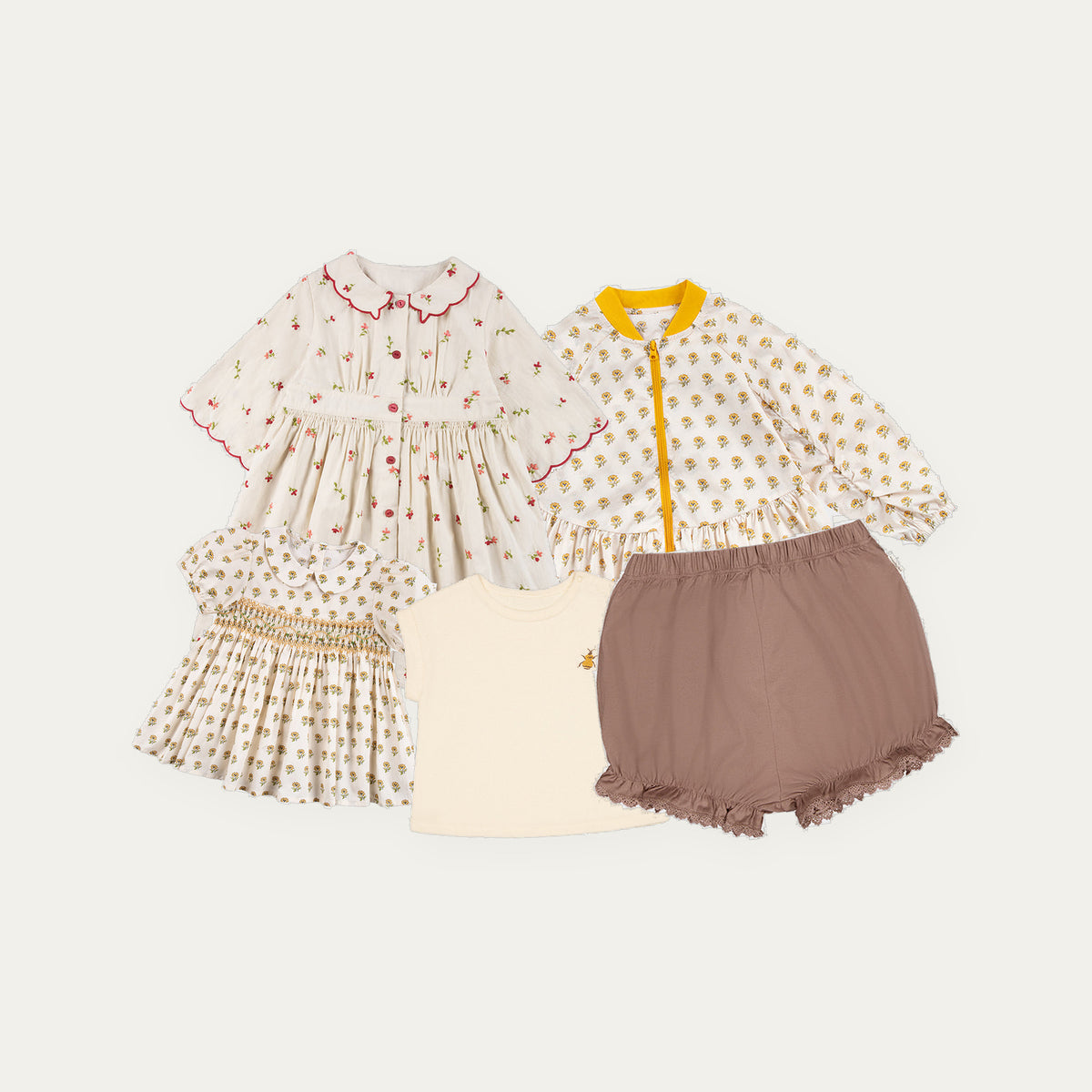 Happyology Lucky Bag, five spring summer sample pieces laid out - cherry print dress, jacket, blouse, tee and bloomers